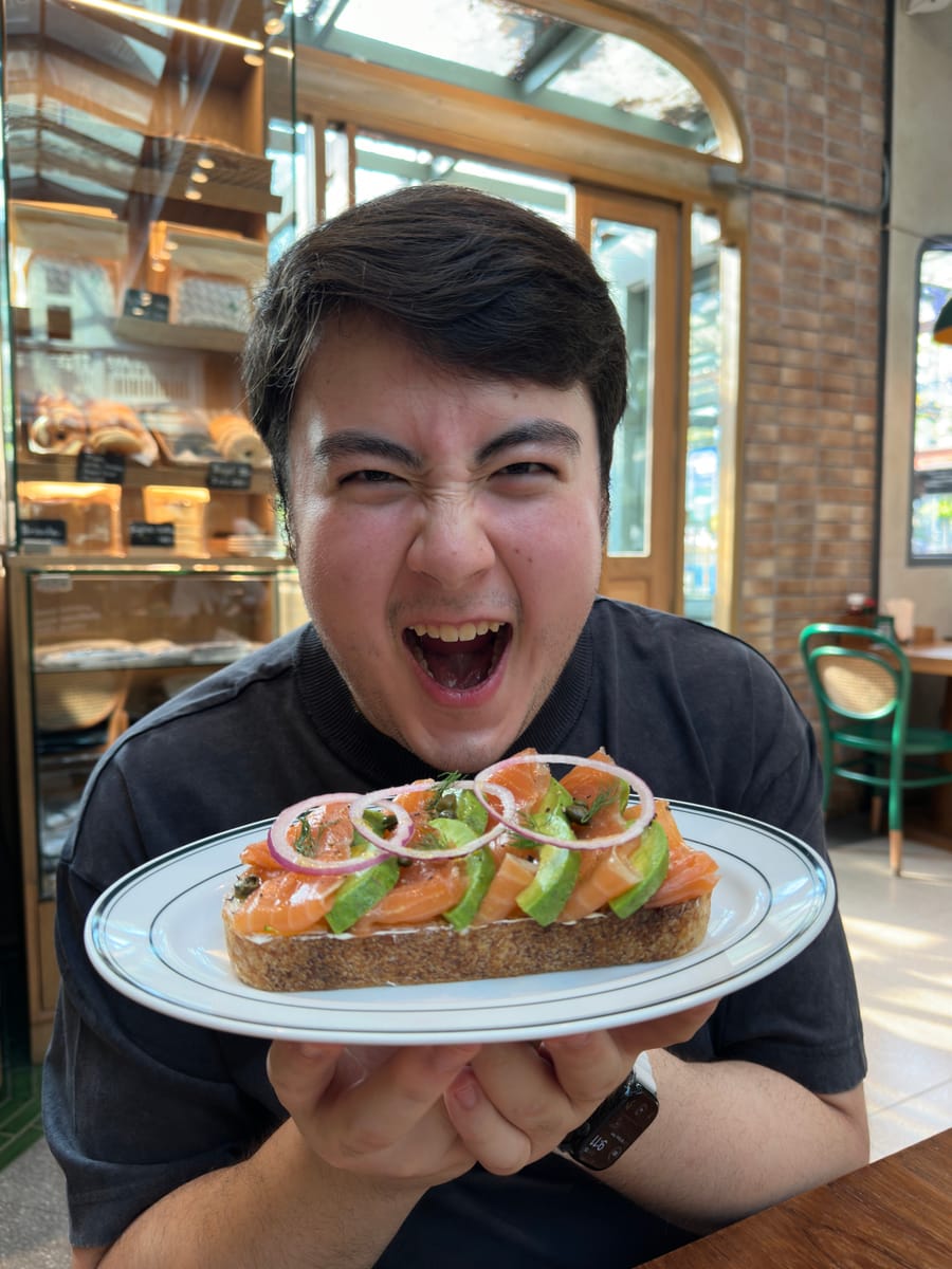 Me, mouth wide open, about to devour the salmon avocado toast at Fran's